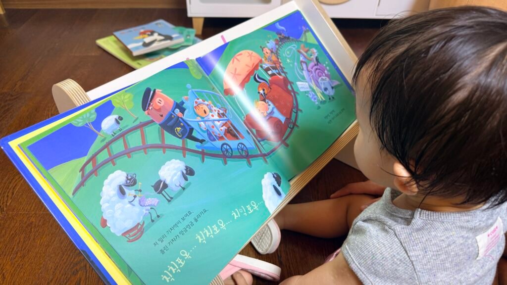 Toddler reading a Doremi Gom picture book