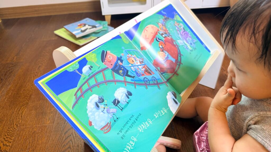 Toddler reacting to a picture book while reading