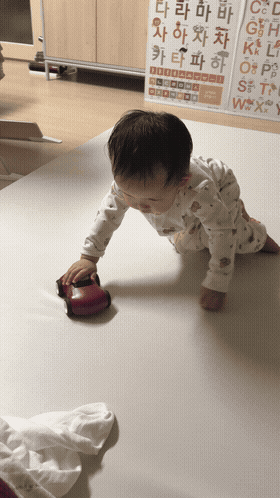 a toddler is playing with finden car