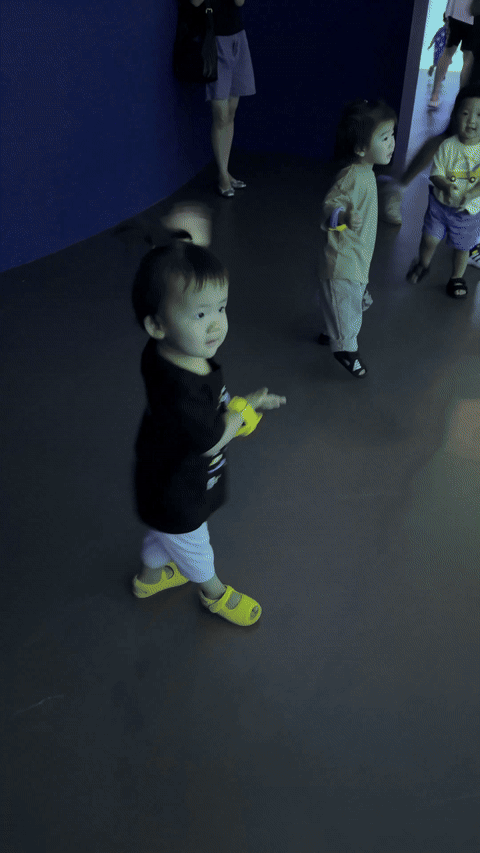 Child dancing to Baby Shark songs in the interactive dance area