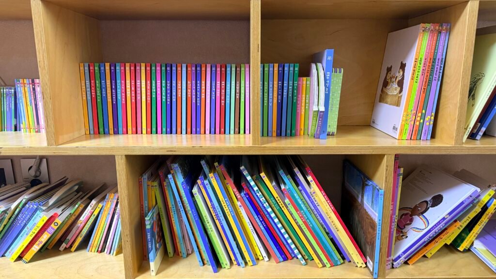 Doremi Bear and Bebe Koala Korean children's book sets on a bookshelf