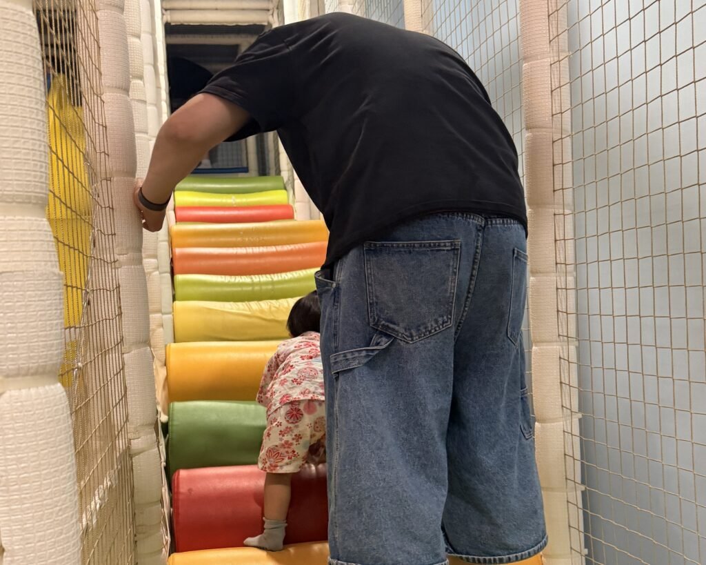 Toddler climbing stairs in the play area at Pororo Theme Park Dasan
