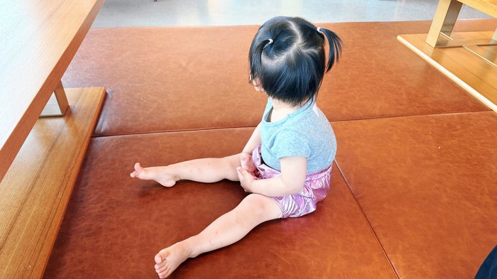 21-month-old toddler playing in the floor seating area at TABLES Lounge