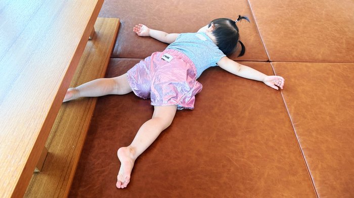 Toddler enjoying the second-floor floor seating at TABLES Lounge