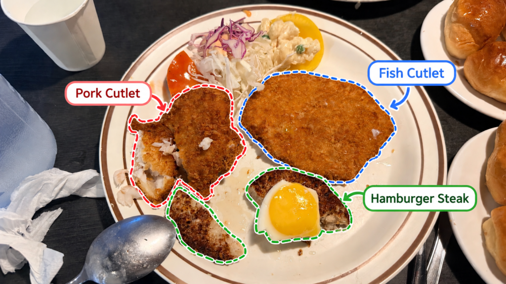 Pork cutlet, fish cutlet, and hamburger steak served on one plate at Donkkaseu-ui Jip