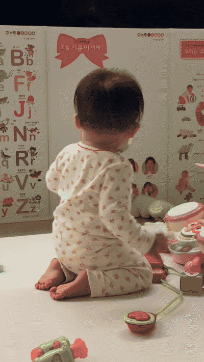 Toddler dancing in front of a Pororo mini drum