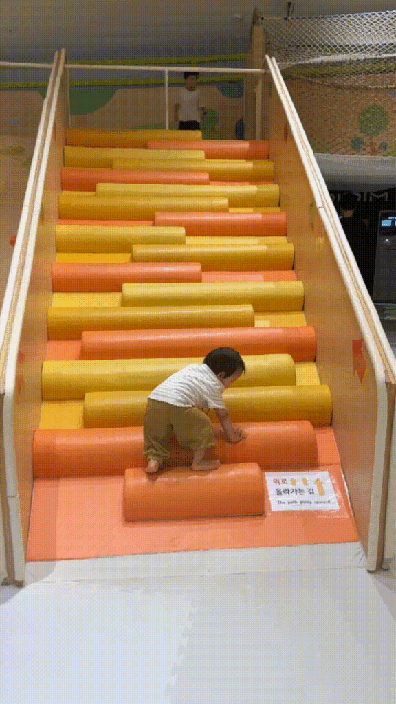 Toddler climbing and playing in the Jeonggeonneok (정글언덕) area
