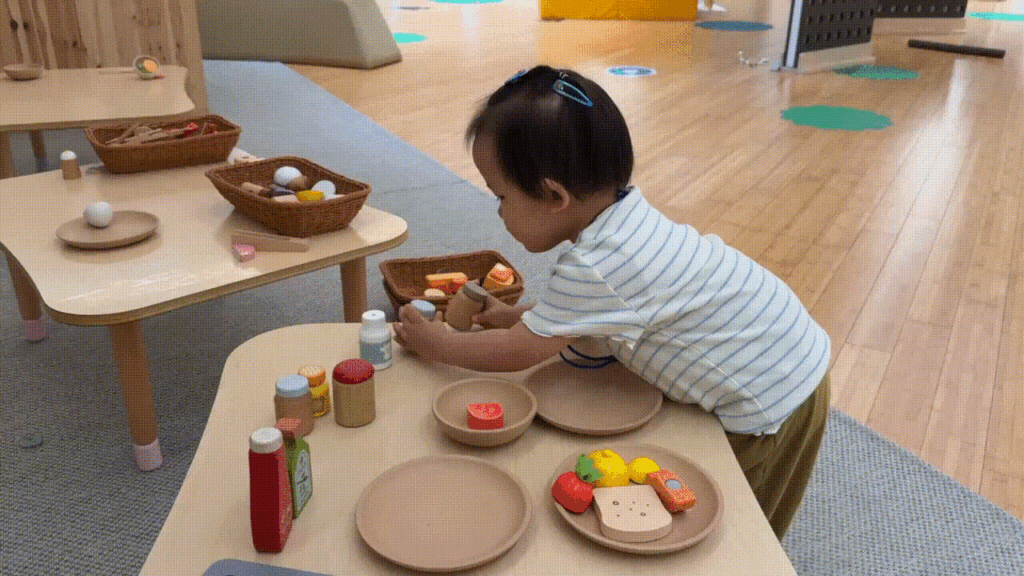 Toddler playing in the Ongdalsaem (옹달샘) pretend-play area